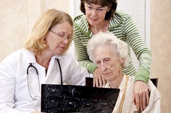 Senior woman visiting with her doctor or caregiver